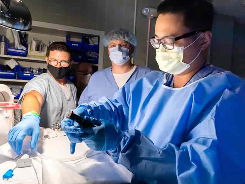 Pulmonologist Dr. Yanglin Guo, right, and respiratory therapist Clint Slade, left, prepare equipment for use in the lung volume reduction procedure.